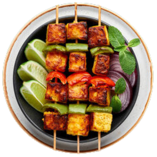 Red Leaf Indian Restaurant - Grill featuring Paneer Tikka skewered with lime on the left and onion on the right